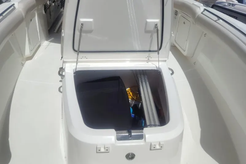  Yacht Photos Pics 2024 Boston Whaler 280 Outrage storage compartment open, showcasing interior space.