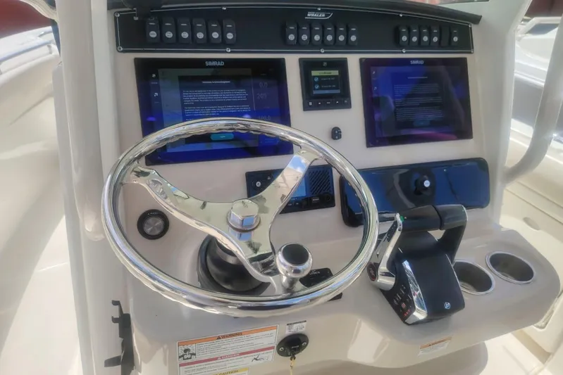  Yacht Photos Pics 2024 Boston Whaler 280 Outrage helm with advanced controls and navigation displays.