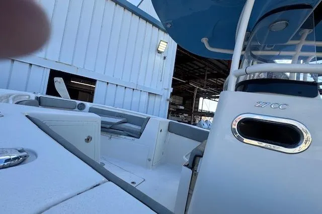  Yacht Photos Pics 2024 Sea Chaser 27 HFC CC boat docked near a warehouse, showcasing sleek design.