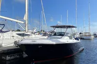 2021 Comitti Isola 33 boat docked in a marina under clear blue skies.