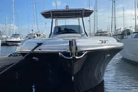 2021 Comitti Isola 33 luxury yacht docked in marina with sailboats.