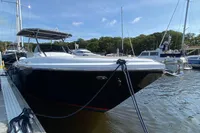 2021 Comitti Isola 33 boat docked in a marina, surrounded by other vessels.