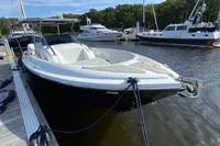 2021 Comitti Isola 33 boat docked at a marina, surrounded by other vessels.