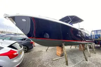 2021 Comitti Isola 33 boat on stands in a marina setting.