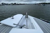 2021 Comitti Isola 33 boat on water, cloudy sky, marina in background.