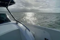 2021 Comitti Isola 33 boat on open water under a cloudy sky.