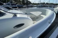 2021 Comitti Isola 33 boat docked, featuring sleek white design and spacious seating area.