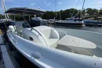 2021 Comitti Isola 33 boat docked, featuring sleek design and spacious seating area.