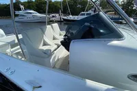 2021 Comitti Isola 33 boat with white seating, docked in a marina.
