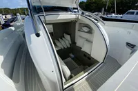 2021 Comitti Isola 33 boat interior with seating and cushions, docked in a marina.