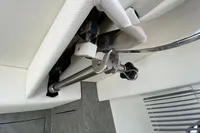 Interior detail of a 2021 Comitti Isola 33 yacht, featuring a metal fixture and white upholstery.
