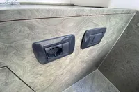 Power outlets on Comitti Isola 33, 2021 model, with elegant wood-patterned paneling.