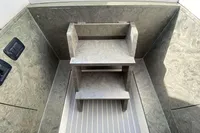 Interior of 2021 Comitti Isola 33 boat with wooden steps and textured walls.