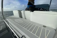 2021 Comitti Isola 33 boat interior with helm, seating, and ocean view.
