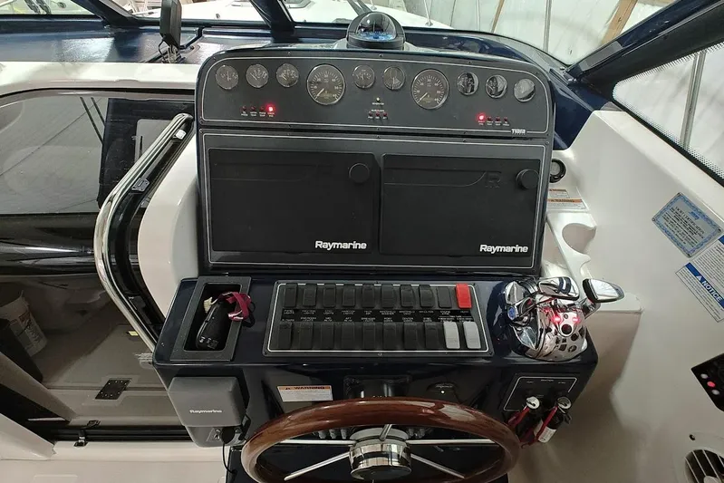 Got Fish Yacht Photos Pics 2005 Tiara Yachts 3200 Open helm with Raymarine electronics and wooden steering wheel.