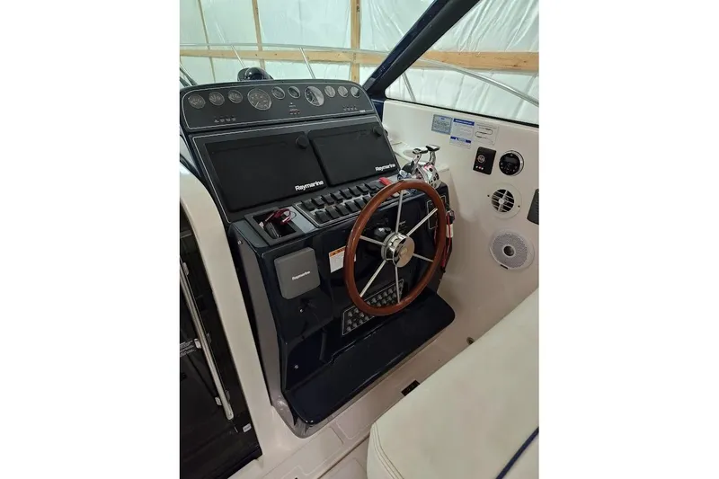 Got Fish Yacht Photos Pics 2005 Tiara Yachts 3200 Open helm with Raymarine electronics and wooden steering wheel.