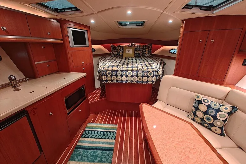 Got Fish Yacht Photos Pics Luxurious interior of 2005 Tiara Yachts 3200 Open with cozy bed and elegant wood finish.
