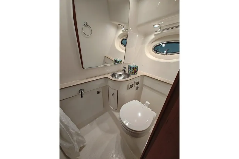Got Fish Yacht Photos Pics Luxurious bathroom in 2005 Tiara Yachts 3200 Open, featuring modern fixtures and porthole window.