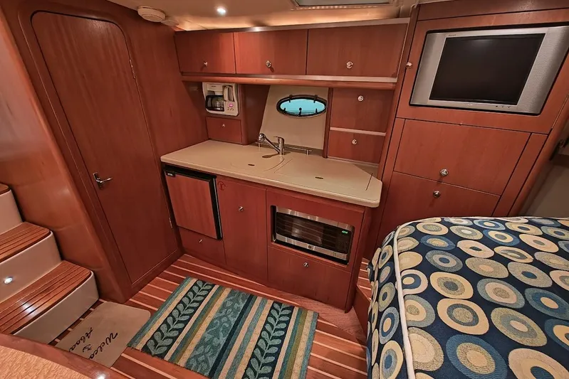 Got Fish Yacht Photos Pics 2005 Tiara Yachts 3200 Open interior with kitchenette, wood cabinetry, and cozy seating area.