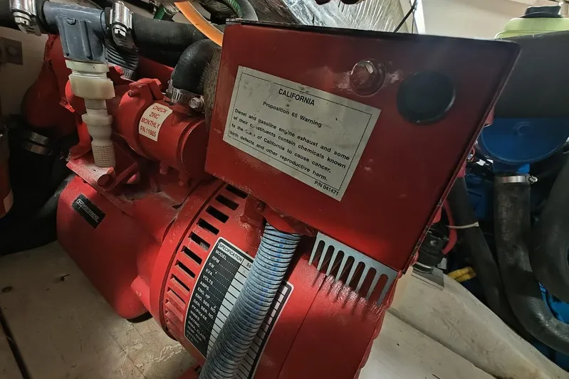 Got Fish Yacht Photos Pics Engine compartment of a 2005 Tiara Yachts 3200 Open, featuring a red generator with warning label.