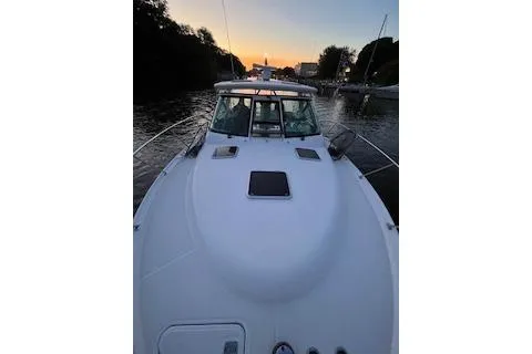 Got Fish Yacht Photos Pics 2005 Tiara Yachts 3200 Open boat at sunset on a calm waterway.