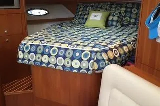 Got Fish Yacht Photos Pics Cozy cabin interior of 2005 Tiara Yachts 3200 Open with patterned bedding.