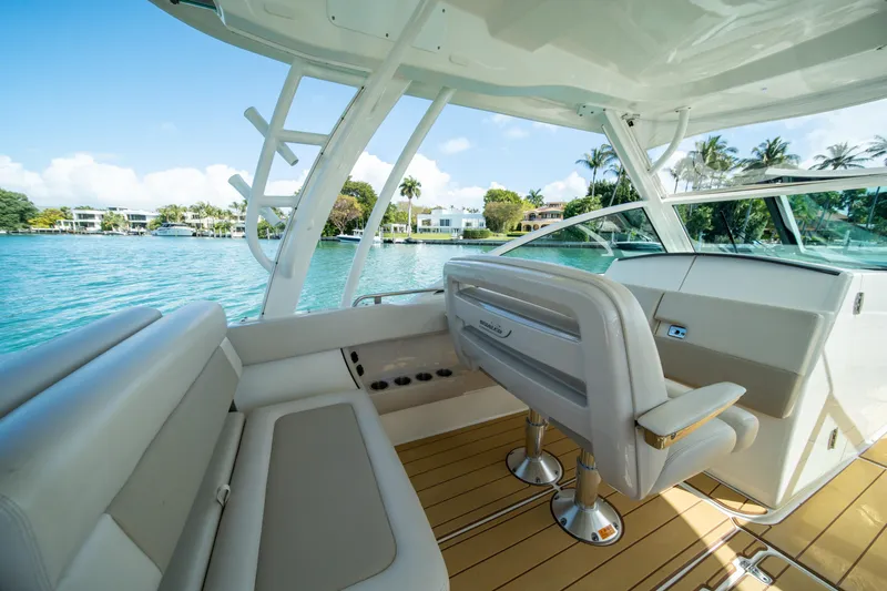  Yacht Photos Pics 2018 Boston Whaler 320 Vantage boat interior with luxurious seating and scenic water view.