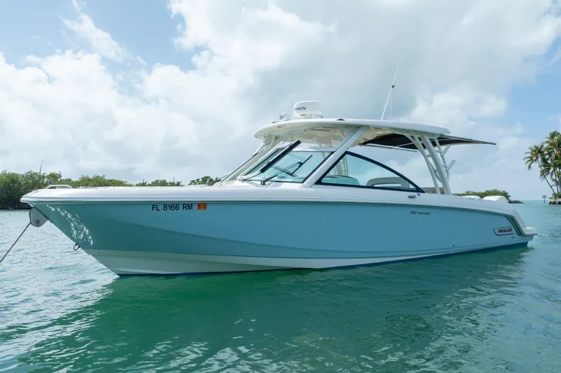  Yacht Photos Pics 2018 Boston Whaler 320 Vantage boat on calm water under a cloudy sky.