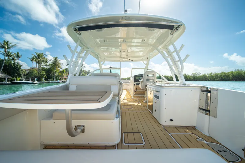  Yacht Photos Pics 2018 Boston Whaler 320 Vantage boat interior with seating and table, under sunny skies.