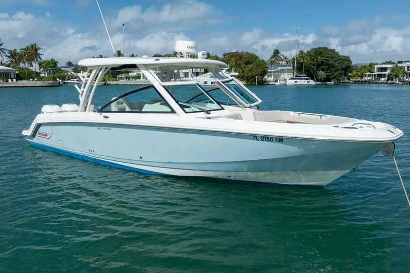  Yacht Photos Pics 2018 Boston Whaler 320 Vantage boat on calm water, clear sky background.