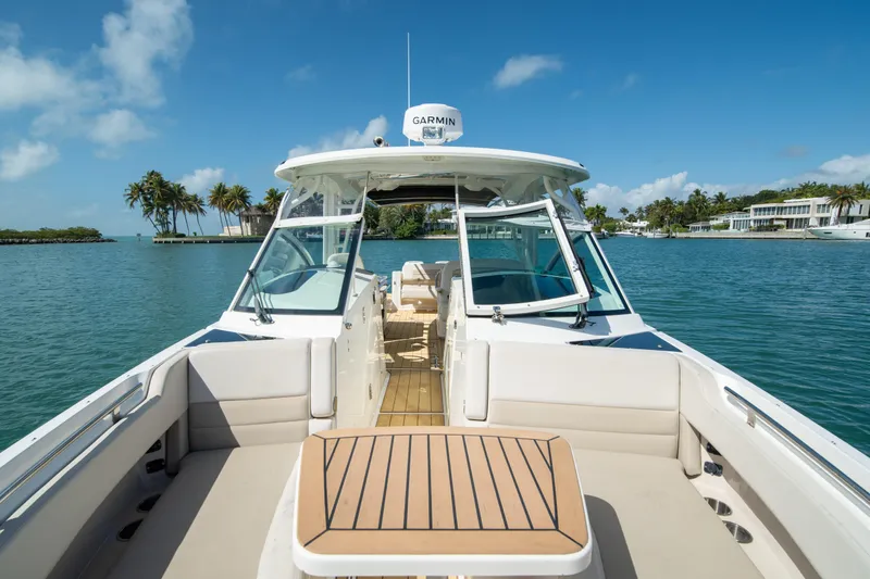  Yacht Photos Pics 2018 Boston Whaler 320 Vantage boat on serene water with clear blue sky.