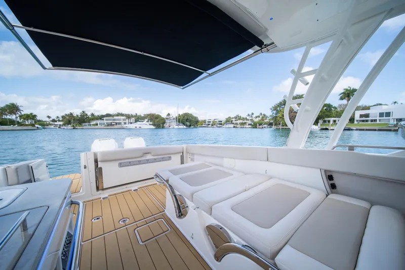  Yacht Photos Pics 2018 Boston Whaler 320 Vantage boat interior with waterfront view, featuring comfortable seating.