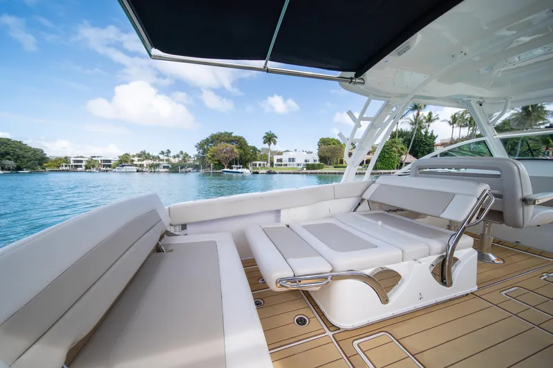  Yacht Photos Pics 2018 Boston Whaler 320 Vantage boat interior with seating, overlooking serene waterfront.