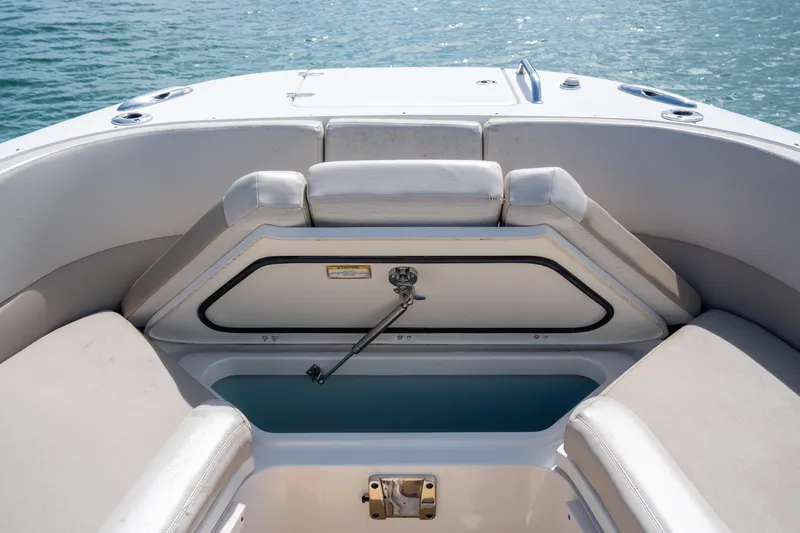  Yacht Photos Pics 2018 Boston Whaler 320 Vantage boat interior with open storage compartment, on calm water.
