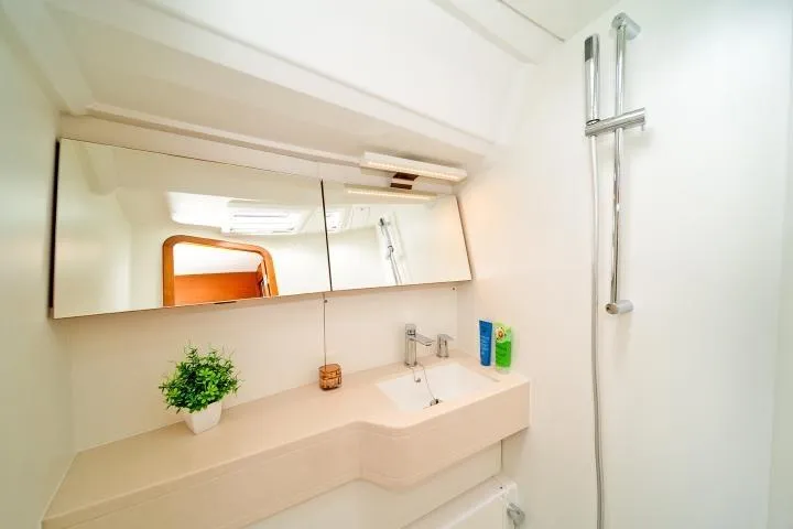 One Heart Yacht Photos Pics Modern bathroom in 2025 Dufour 44 yacht with sleek fixtures and mirrored cabinets.