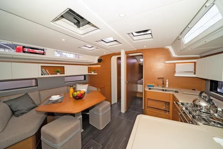 One Heart Yacht Photos Pics Modern interior of 2025 Dufour 44 yacht with kitchen and dining area.