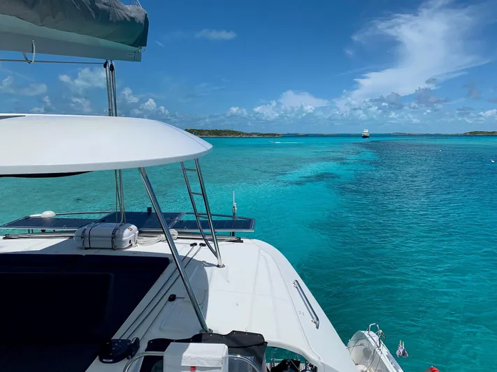 Clearlake III Yacht Photos Pics Lagoon 46 catamaran sailing in clear turquoise waters under a bright blue sky.
