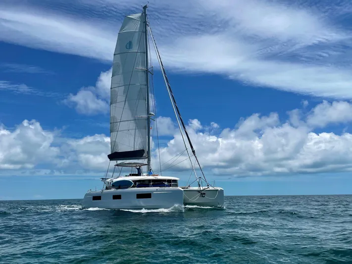 Clearlake III Yacht Photos Pics 2021 Lagoon 46 catamaran sailing on open sea under a clear blue sky.