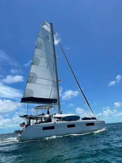 Clearlake III Yacht Photos Pics 2021 Lagoon 46 catamaran sailing on open sea under clear blue sky.
