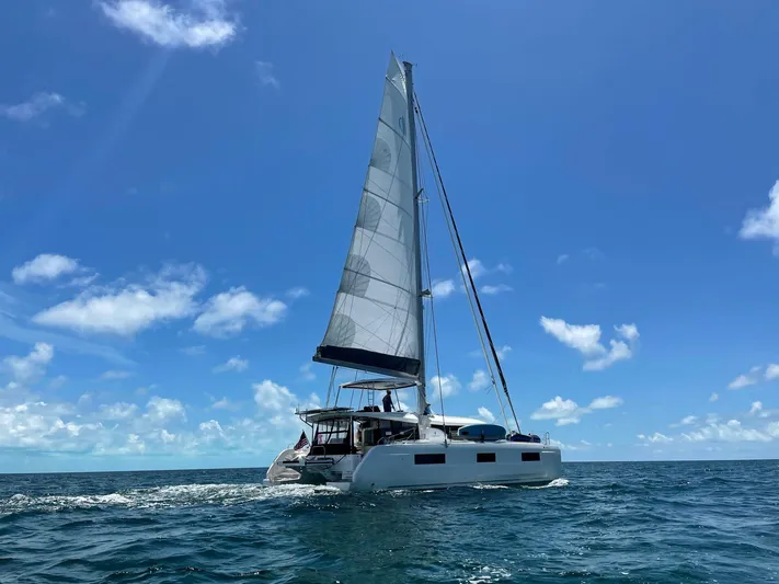 Clearlake III Yacht Photos Pics 2021 Lagoon 46 catamaran sailing on open sea under clear blue sky.