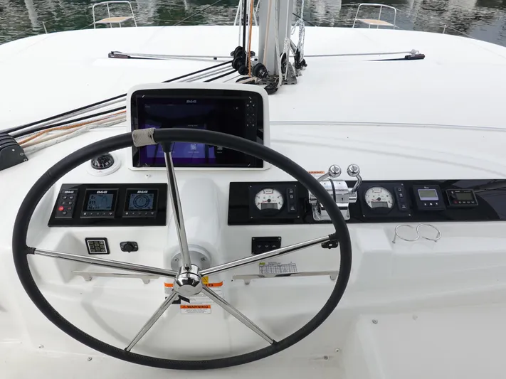 Clearlake III Yacht Photos Pics Helm of 2021 Lagoon 46 catamaran with navigation instruments and steering wheel.
