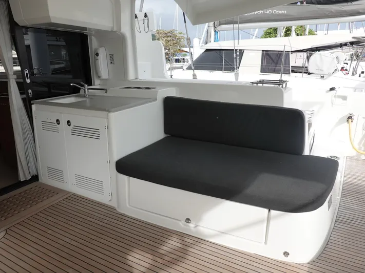 Clearlake III Yacht Photos Pics 2021 Lagoon 46 yacht interior with seating and kitchenette area.