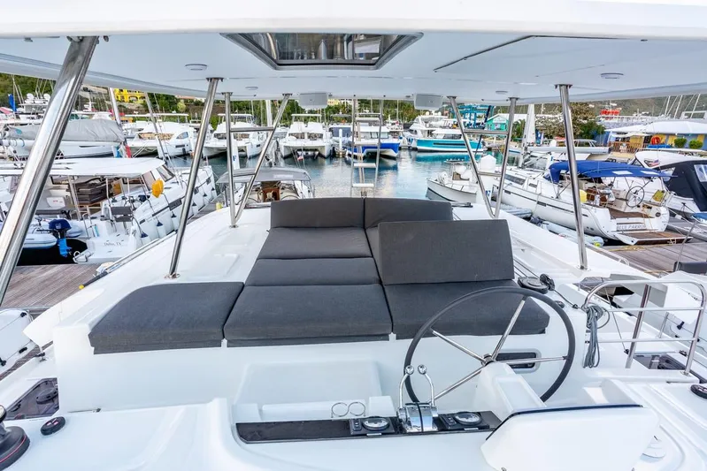 Clearlake III Yacht Photos Pics Luxurious 2021 Lagoon 46 catamaran with spacious deck and modern helm, docked at marina.