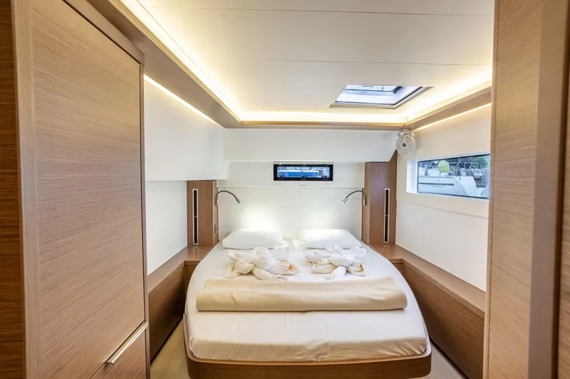 Clearlake III Yacht Photos Pics Luxurious bedroom interior of 2021 Lagoon 46 yacht with modern lighting and cozy bedding.