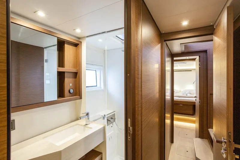 Clearlake III Yacht Photos Pics Luxurious bathroom interior of 2021 Lagoon 46 yacht, featuring modern fixtures and wooden accents.