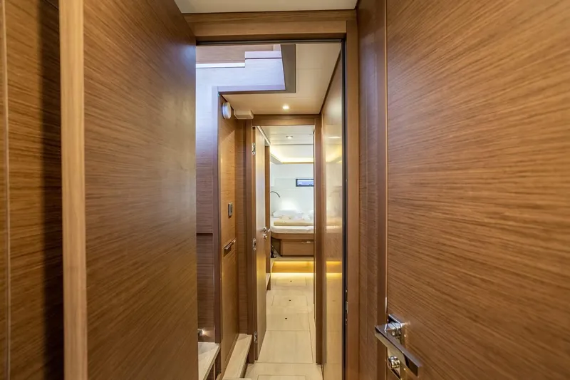 Clearlake III Yacht Photos Pics Interior hallway of 2021 Lagoon 46 yacht with wooden paneling and modern lighting.