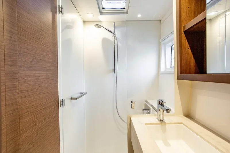 Clearlake III Yacht Photos Pics Modern bathroom in 2021 Lagoon 46 yacht with shower and sleek fixtures.