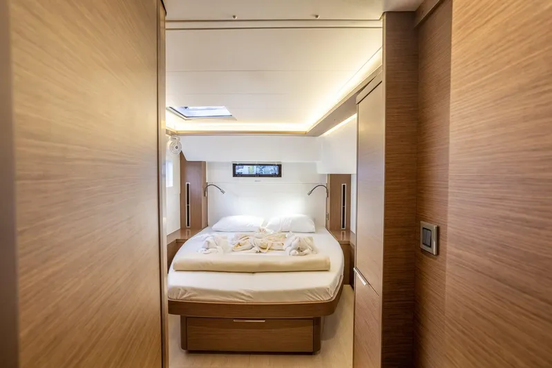 Clearlake III Yacht Photos Pics Luxurious cabin interior of 2021 Lagoon 46 catamaran with cozy bed and modern lighting.