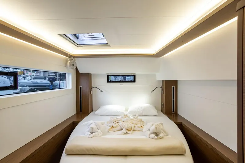 Clearlake III Yacht Photos Pics Luxurious cabin interior of 2021 Lagoon 46 yacht with elegant bedding and ambient lighting.