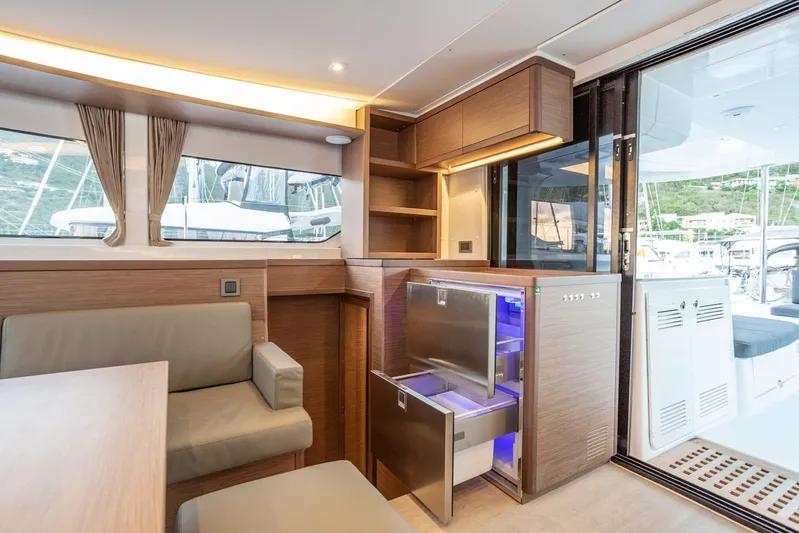 Clearlake III Yacht Photos Pics Modern interior of 2021 Lagoon 46 yacht with seating and open fridge.